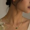 Green Crystal Gold Short Chain Necklace for Women featuring a radiant green crystal and elegant gold-tone chain